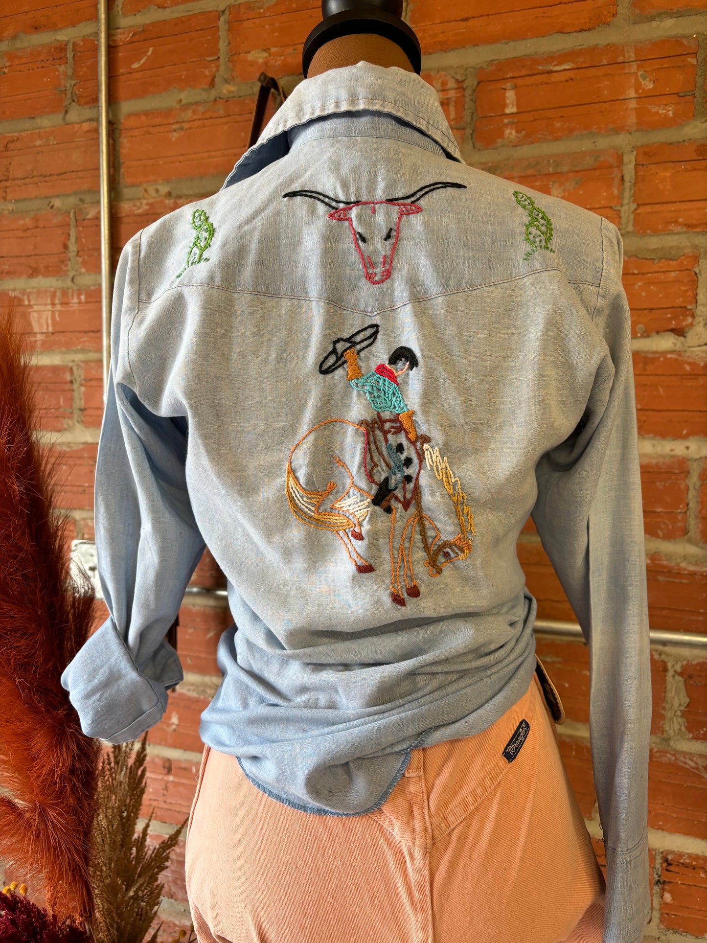 Hand embroidered pearl snap